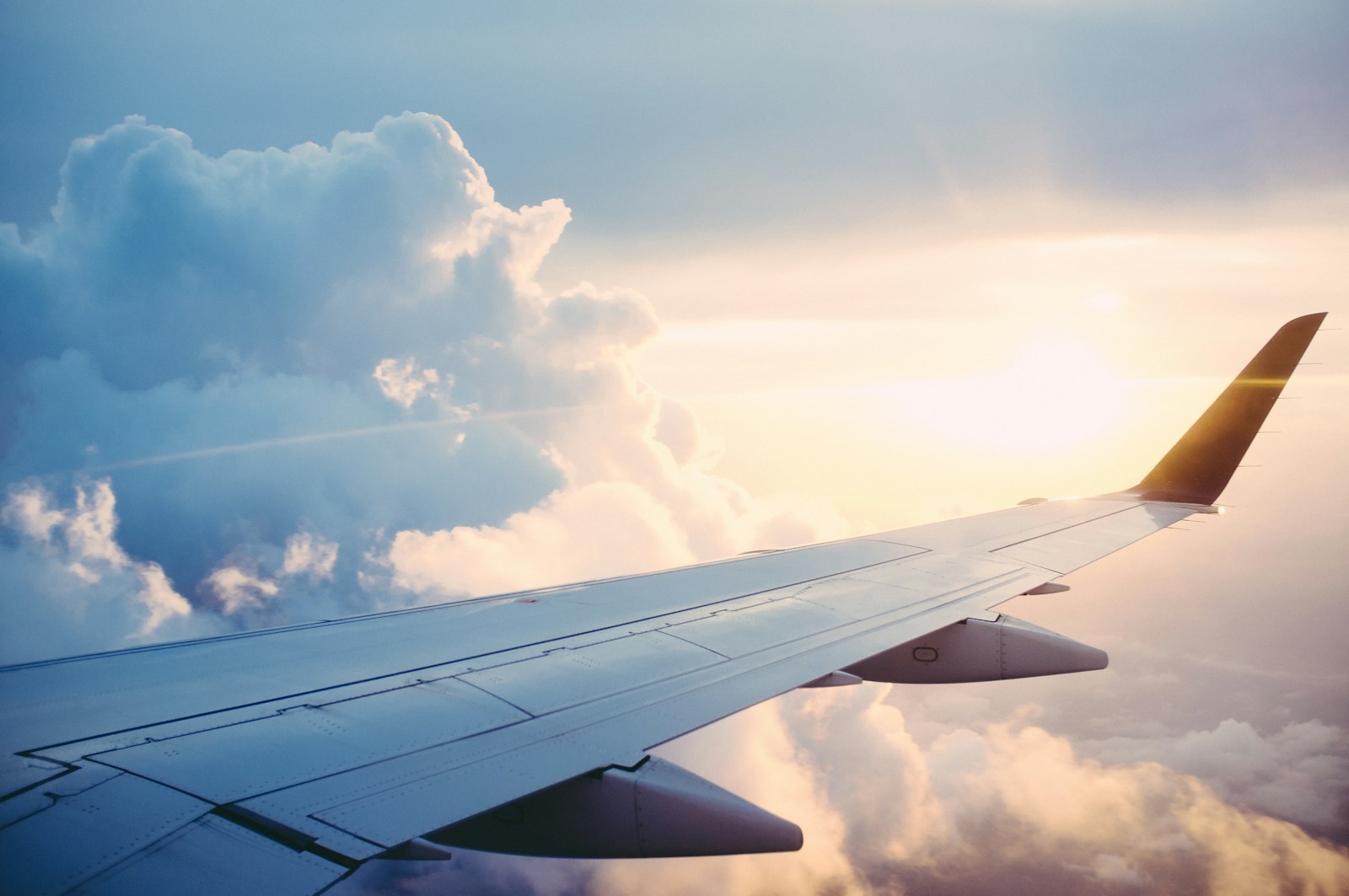 Airliner wing above the clouds at altitude